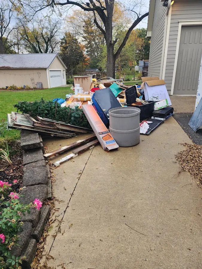 Dumpster being loaded with debris for Estate Cleanout Dumpster Rental in Stuart